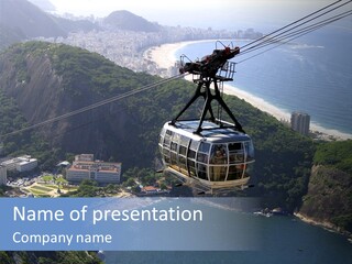 A Cable Car Going Up A Mountain With A City In The Background PowerPoint Template