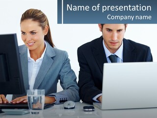 A Man And A Woman Sitting At A Desk In Front Of A Computer PowerPoint Template