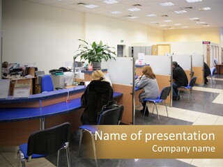 A Group Of People Sitting At Desks In An Office PowerPoint Template
