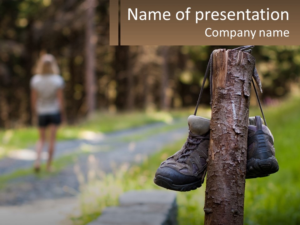 A Pair Of Shoes Hanging From A Tree Trunk PowerPoint Template