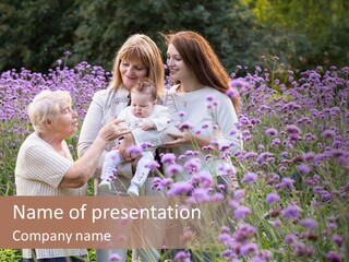 A Group Of Women Holding A Baby In A Field Of Flowers PowerPoint Template