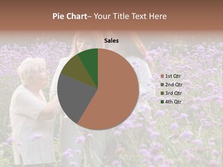 A Group Of Women Holding A Baby In A Field Of Flowers PowerPoint Template