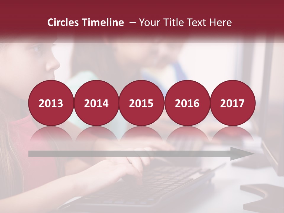 A Group Of Children Sitting At A Computer PowerPoint Template