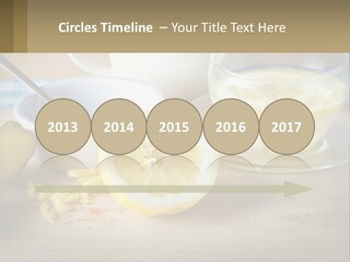 A Table Topped With A Bowl Of Lemons And A Cup Of Tea PowerPoint Template
