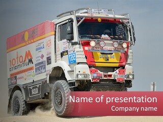 A Large Truck Driving Down A Sandy Road PowerPoint Template