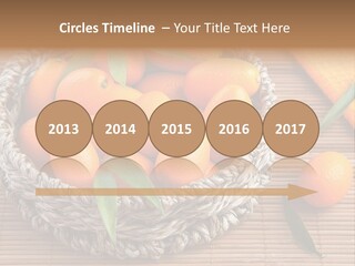 A Basket Filled With Oranges On Top Of A Bamboo Mat PowerPoint Template