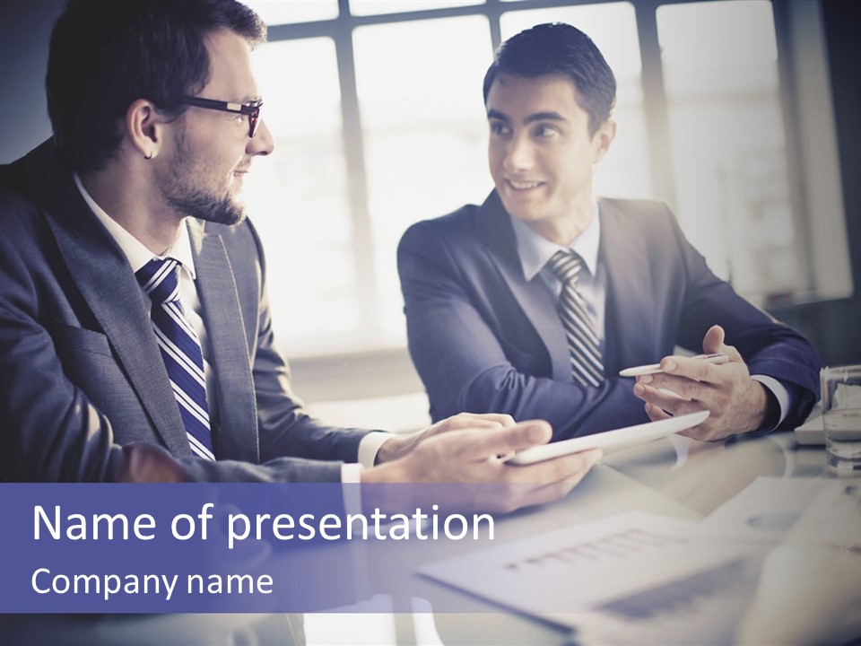 Two Men In Business Suits Sitting At A Table PowerPoint Template