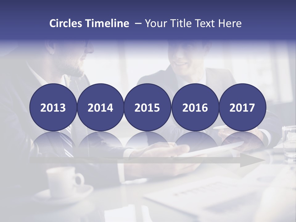 Two Men In Business Suits Sitting At A Table PowerPoint Template