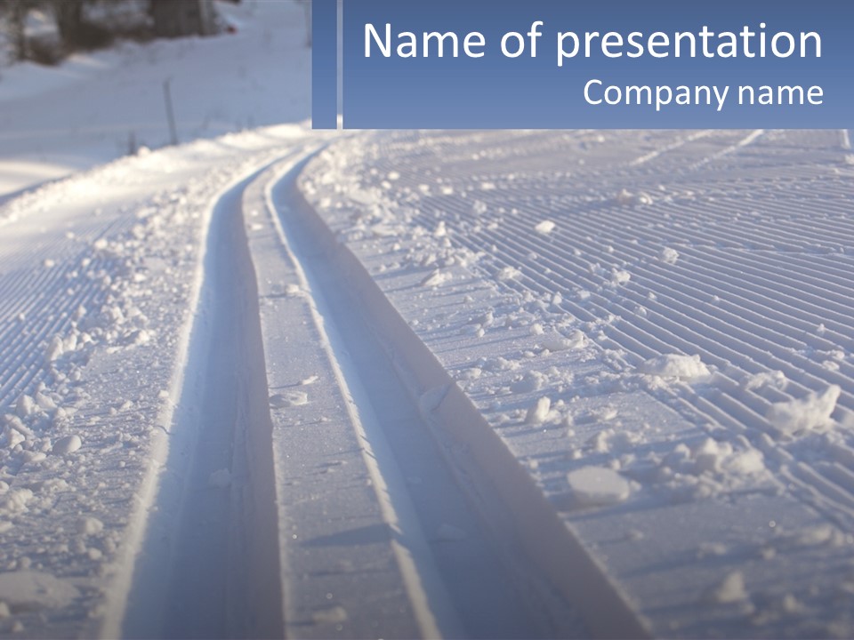 A Snow Covered Road With Tracks In The Snow PowerPoint Template