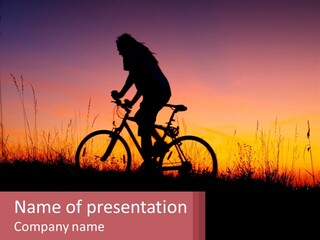 A Person Riding A Bike At Sunset Powerpoint Template PowerPoint Template