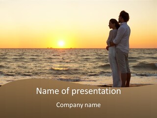 Two People Standing On A Beach At Sunset PowerPoint Template