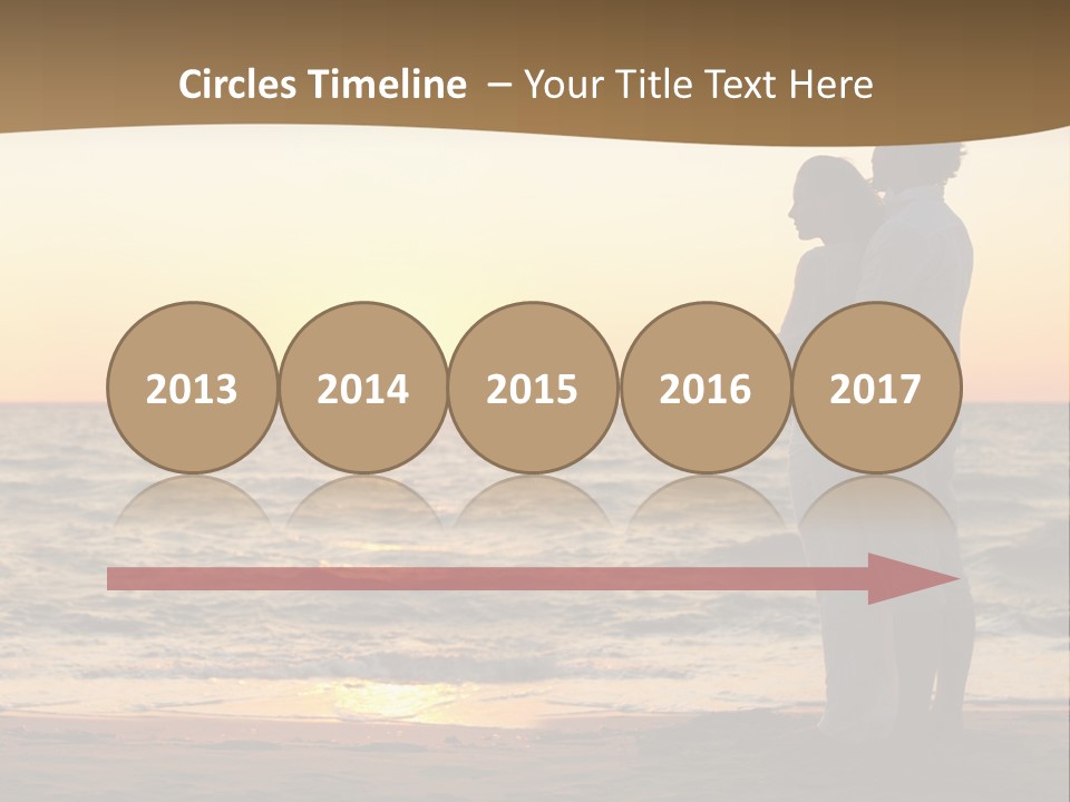 Two People Standing On A Beach At Sunset PowerPoint Template