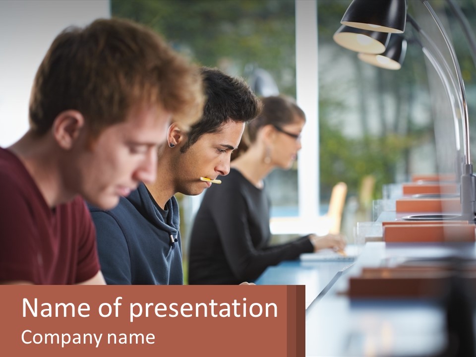 A Group Of Men Sitting At A Table With Laptops PowerPoint Template