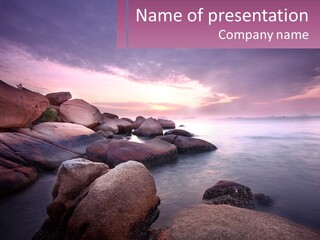 A Rocky Beach With Rocks In The Water PowerPoint Template