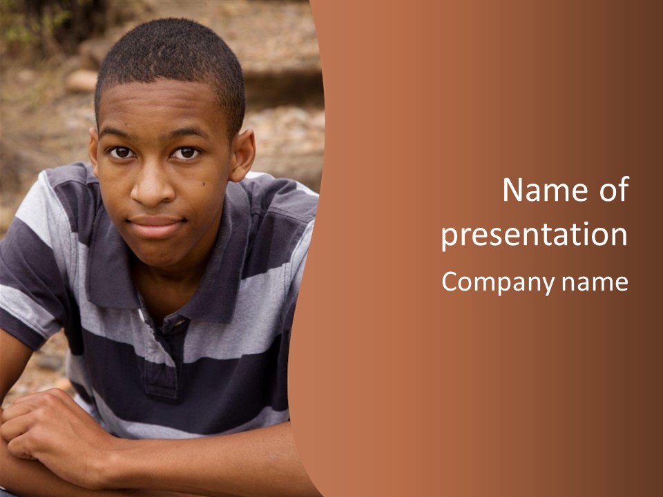 A Young Boy Is Posing For A Picture PowerPoint Template
