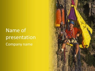 A Man Climbing Up The Side Of A Mountain PowerPoint Template