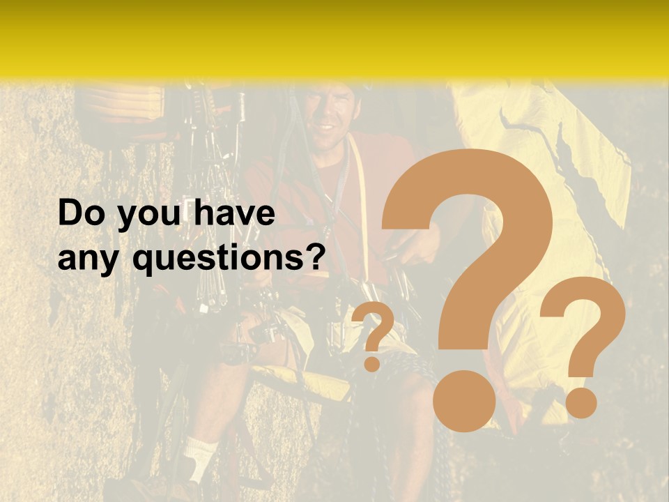 A Man Climbing Up The Side Of A Mountain PowerPoint Template