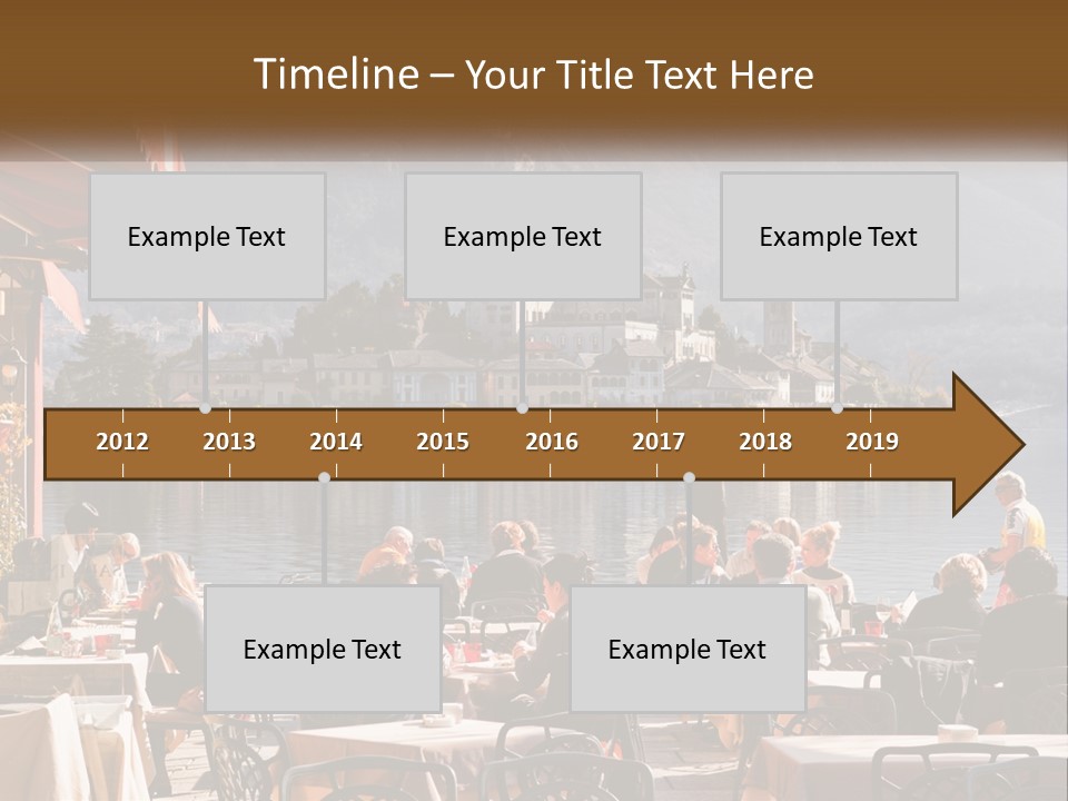 A Group Of People Sitting At A Table In Front Of A Lake PowerPoint Template