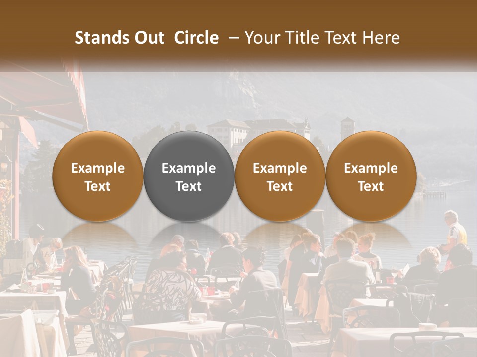 A Group Of People Sitting At A Table In Front Of A Lake PowerPoint Template