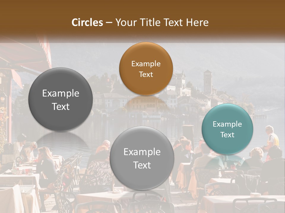 A Group Of People Sitting At A Table In Front Of A Lake PowerPoint Template