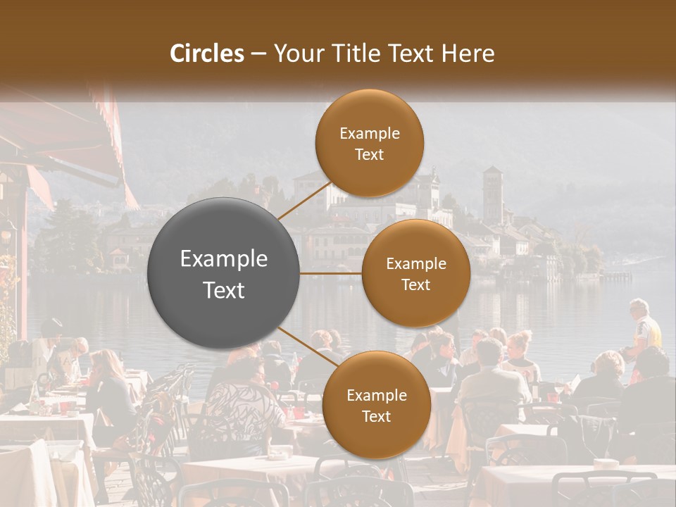 A Group Of People Sitting At A Table In Front Of A Lake PowerPoint Template