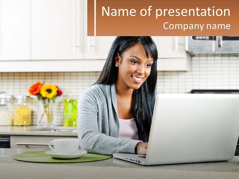Girl At The Laptop In The Kitchen PowerPoint Template