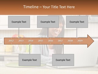 Girl At The Laptop In The Kitchen PowerPoint Template