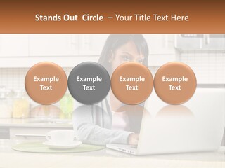 Girl At The Laptop In The Kitchen PowerPoint Template