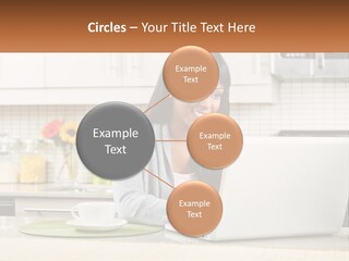 Girl At The Laptop In The Kitchen PowerPoint Template