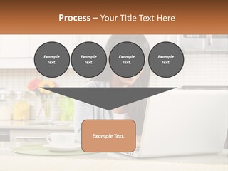 Girl At The Laptop In The Kitchen PowerPoint Template
