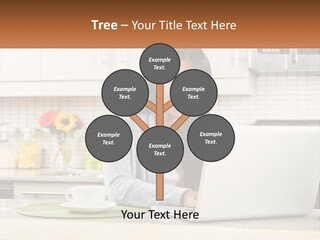 Girl At The Laptop In The Kitchen PowerPoint Template
