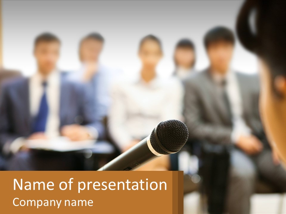 A Microphone In Front Of A Group Of People PowerPoint Template