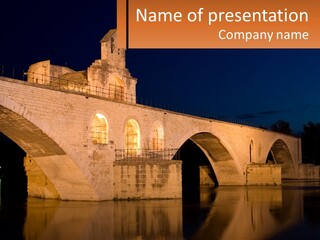 A Bridge Over A Body Of Water At Night PowerPoint Template