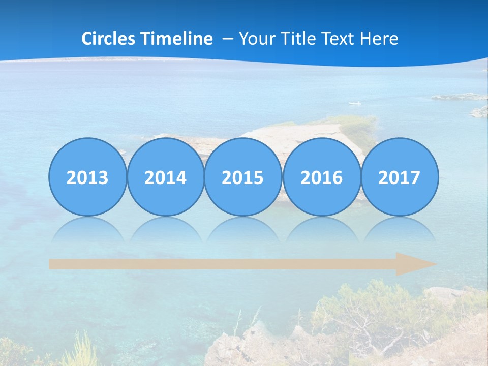 A Beautiful Blue Ocean With A Sandy Beach In The Foreground PowerPoint Template