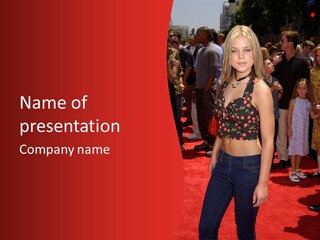A Woman Standing On A Red Carpet In Front Of A Crowd PowerPoint Template