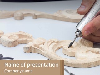 A Person Is Carving A Piece Of Wood With A Drill PowerPoint Template
