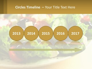 A Salad With Cucumbers And Olives On A Plate PowerPoint Template