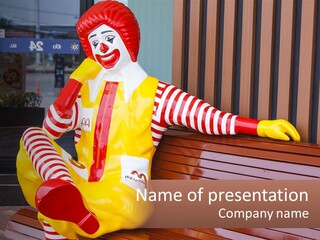A Clown Sitting On A Bench In Front Of A Building PowerPoint Template