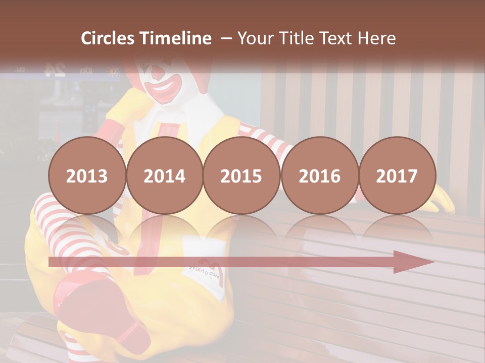 A Clown Sitting On A Bench In Front Of A Building PowerPoint Template