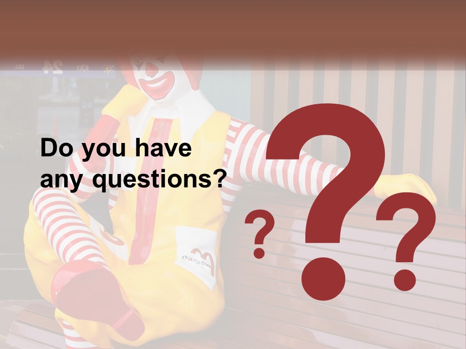 A Clown Sitting On A Bench In Front Of A Building PowerPoint Template