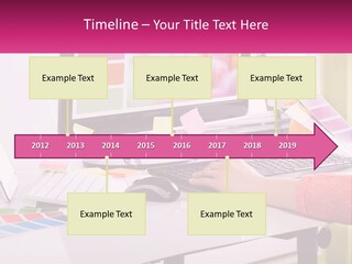 A Woman Sitting At A Desk Using A Computer PowerPoint Template