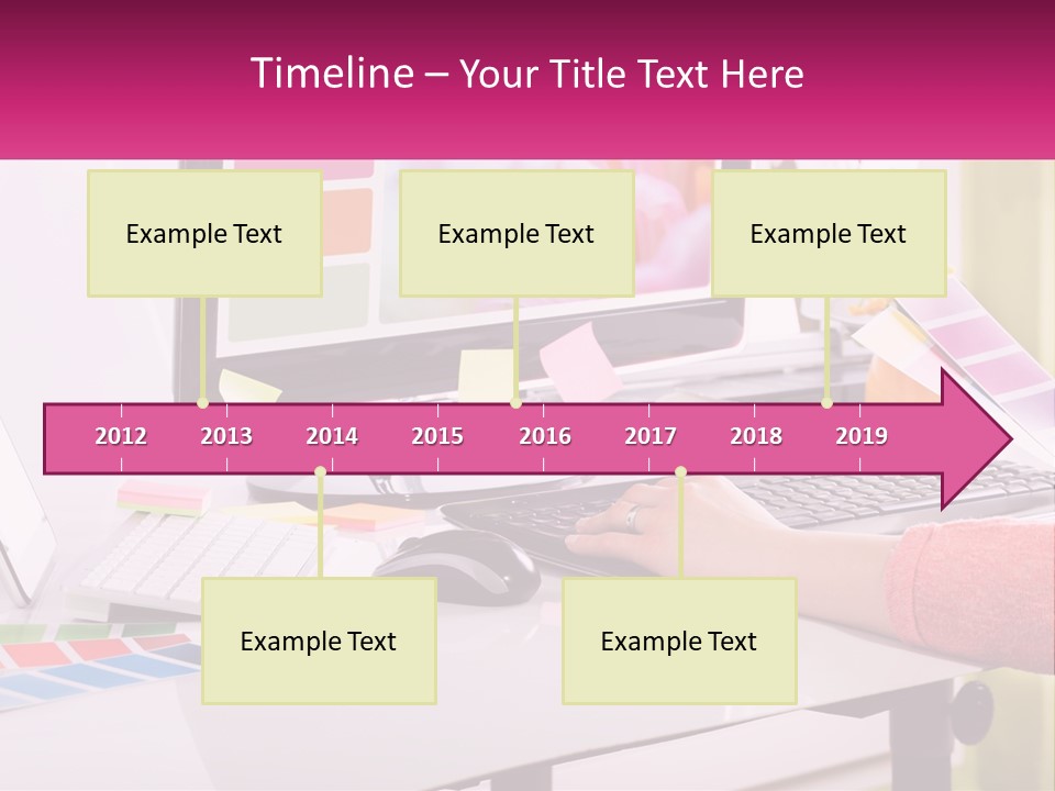A Woman Sitting At A Desk Using A Computer PowerPoint Template