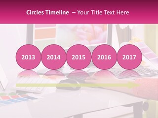 A Woman Sitting At A Desk Using A Computer PowerPoint Template