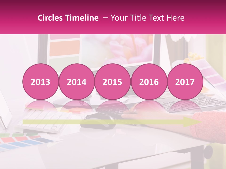 A Woman Sitting At A Desk Using A Computer PowerPoint Template