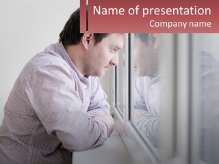 A Man Looking Out Of A Window With His Hand On His Head PowerPoint Template