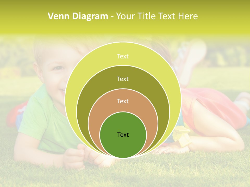 Two Young Children Laying On The Grass In A Park PowerPoint Template