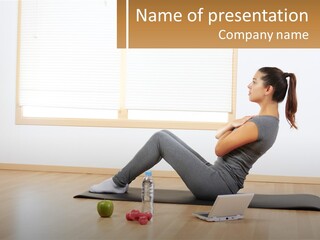 A Woman Sitting On A Yoga Mat With A Laptop PowerPoint Template