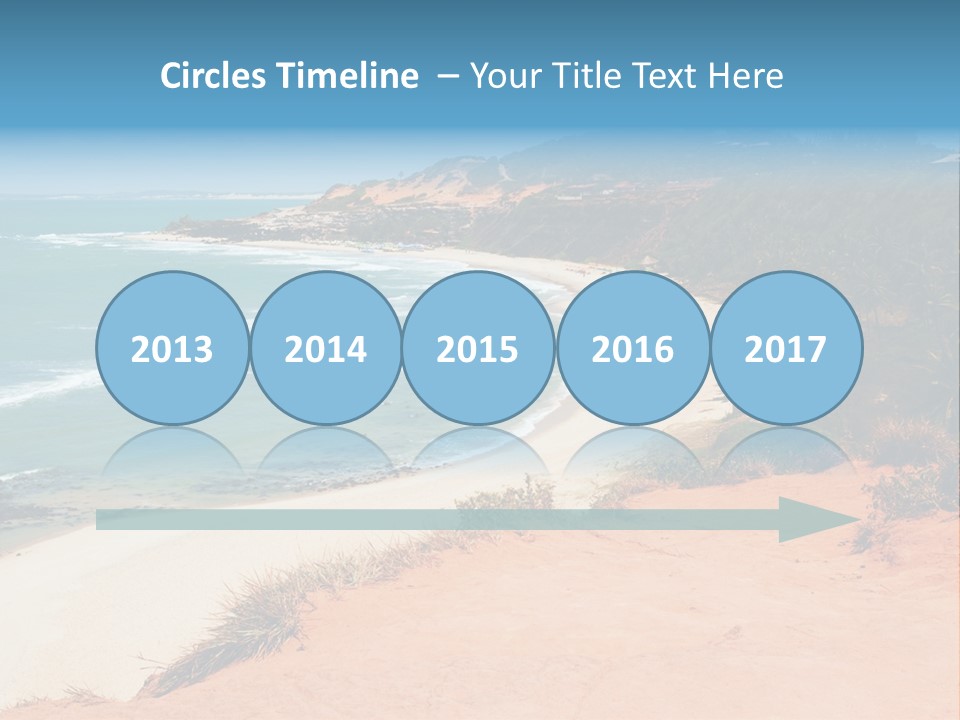 A Sandy Beach With A Body Of Water In The Background PowerPoint Template