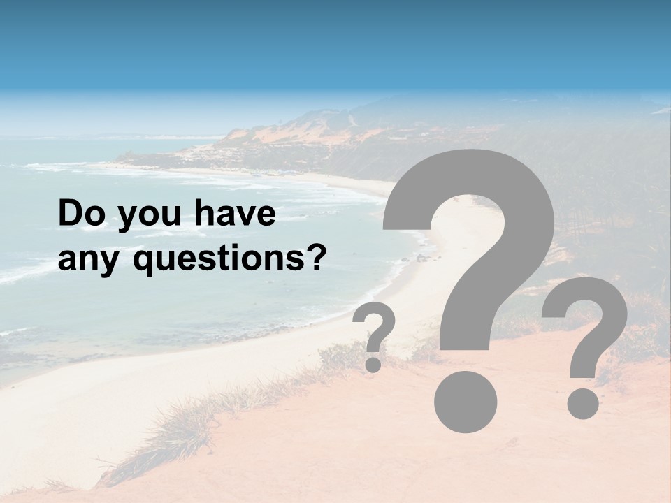 A Sandy Beach With A Body Of Water In The Background PowerPoint Template