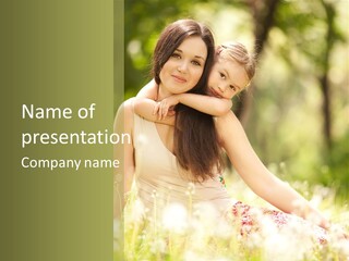 A Woman And A Child Are Sitting In The Grass PowerPoint Template